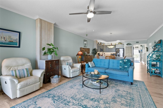 80 Surfview Dr Unit 721, Palm Coast, FL 32137 - living area with crown molding, ceiling fan, light wood finished floors, and a textured ceiling