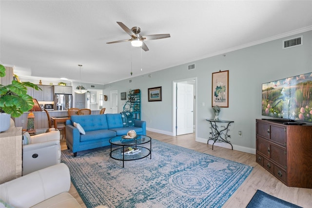 80 Surfview Dr Unit 721, Palm Coast, FL 32137 - living area featuring a ceiling fan, light wood-style floors, and crown molding