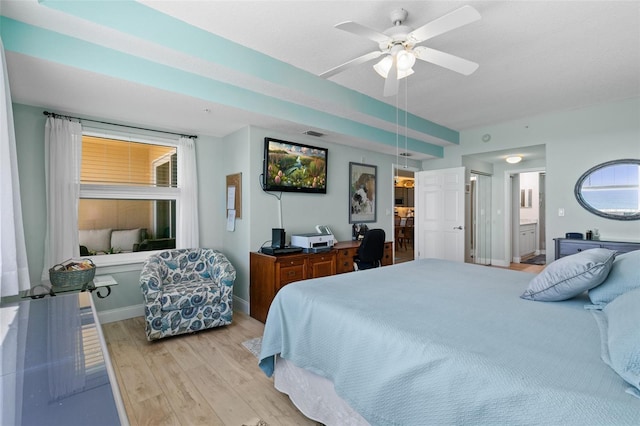 80 Surfview Dr Unit 721, Palm Coast, FL 32137 - bedroom featuring light wood-style floors, ensuite bath, a desk, and ceiling fan