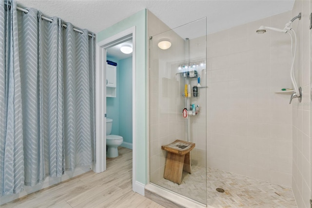 80 Surfview Dr Unit 721, Palm Coast, FL 32137 - full bathroom with wood finished floors, a shower stall, and a textured ceiling