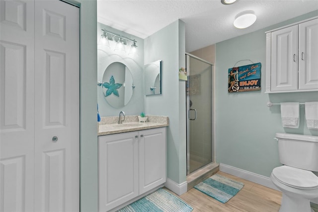 80 Surfview Dr Unit 721, Palm Coast, FL 32137 - full bathroom with a shower stall, vanity, a closet, wood finished floors, and a textured ceiling