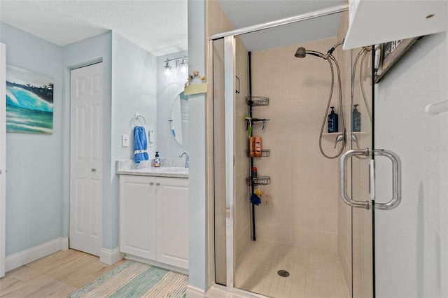 80 Surfview Dr Unit 721, Palm Coast, FL 32137 - bathroom with a stall shower, vanity, and wood finished floors