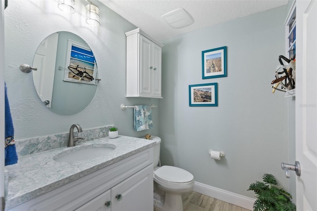 80 Surfview Dr Unit 721, Palm Coast, FL 32137 - half bath featuring vanity, wood finished floors, and a textured ceiling