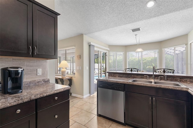 7 White Oak Ln, Palm Coast, FL 32164 - kitchen featuring dishwasher, a sink, plenty of natural light, decorative light fixtures, and a textured ceiling