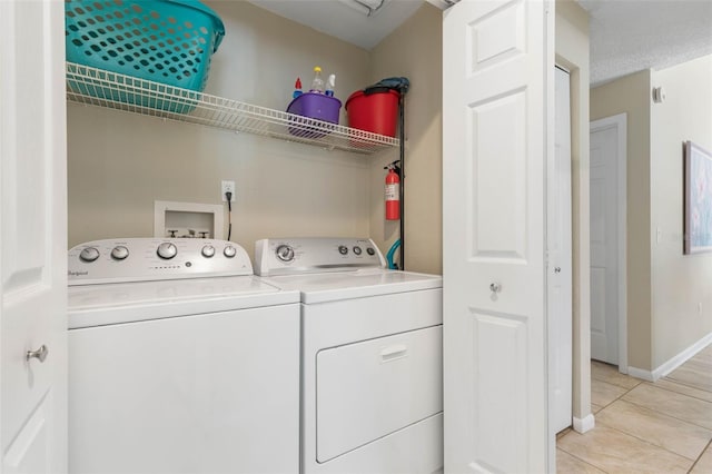 7 White Oak Ln, Palm Coast, FL 32164 - laundry area with separate washer and dryer, light tile patterned floors, and baseboards