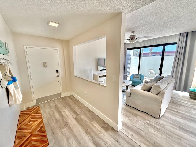 1601 N Central Ave Unit G10, Flagler Beach, FL 32136 - entryway with a textured ceiling, light wood finished floors, a ceiling fan, and baseboards