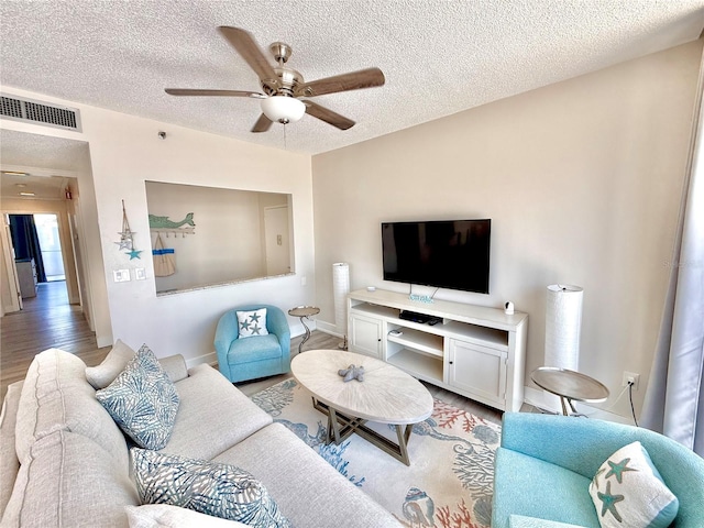 1601 N Central Ave Unit G10, Flagler Beach, FL 32136 - living area featuring a ceiling fan, light wood-style flooring, a textured ceiling, and baseboards