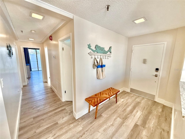 1601 N Central Ave Unit G10, Flagler Beach, FL 32136 - hall featuring a textured ceiling, light wood-style flooring, and baseboards