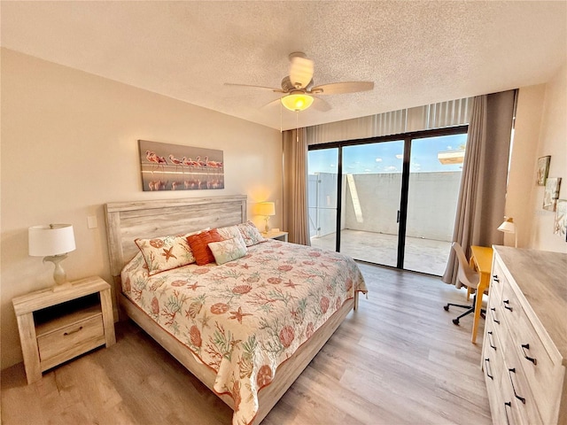 1601 N Central Ave Unit G10, Flagler Beach, FL 32136 - bedroom with wood finished floors, access to outside, a textured ceiling, a desk, and a ceiling fan