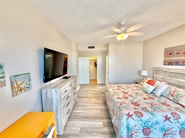 1601 N Central Ave Unit G10, Flagler Beach, FL 32136 - bedroom featuring light wood-style flooring, a textured ceiling, and a ceiling fan
