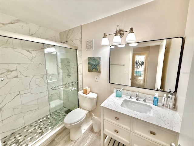 1601 N Central Ave Unit G10, Flagler Beach, FL 32136 - bathroom featuring toilet, a stall shower, vanity, and wood finished floors