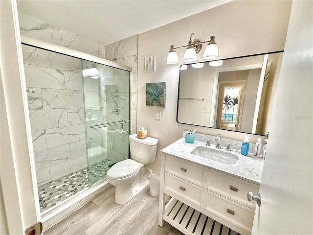 1601 N Central Ave Unit G10, Flagler Beach, FL 32136 - full bathroom with toilet, wood finished floors, a marble finish shower, and vanity