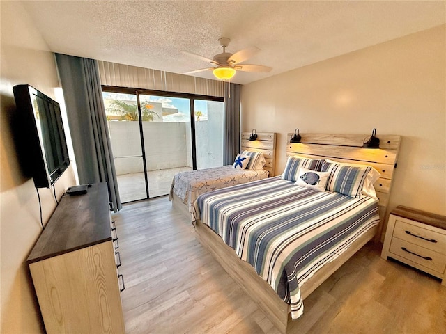 1601 N Central Ave Unit G10, Flagler Beach, FL 32136 - bedroom featuring access to exterior, wood finished floors, a textured ceiling, and a ceiling fan