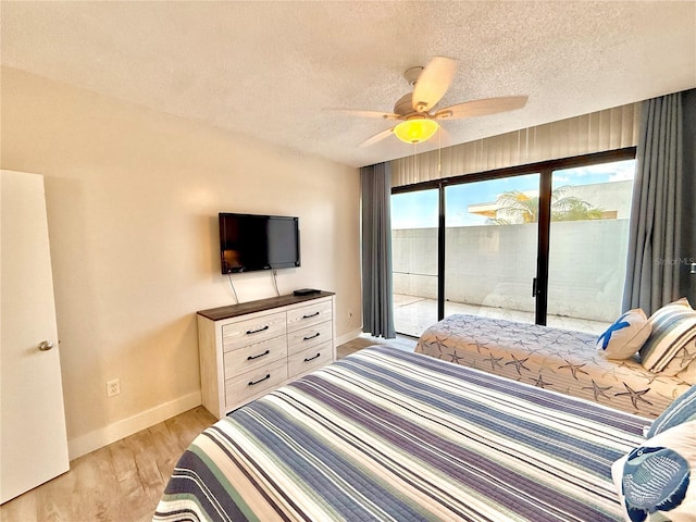 1601 N Central Ave Unit G10, Flagler Beach, FL 32136 - bedroom featuring access to outside, baseboards, a textured ceiling, light wood-style floors, and a ceiling fan