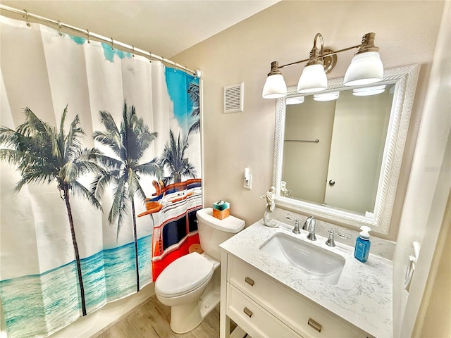 1601 N Central Ave Unit G10, Flagler Beach, FL 32136 - full bathroom featuring toilet, vanity, wood finished floors, and a shower with shower curtain