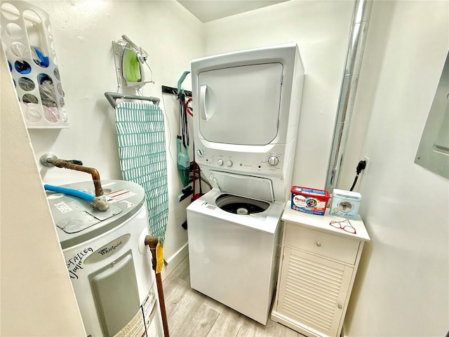 1601 N Central Ave Unit G10, Flagler Beach, FL 32136 - washroom featuring stacked washer / drying machine, electric water heater, and light wood-style floors