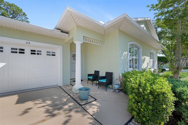 33 Veranda Way Unit 33, Palm Coast, FL 32137 - view of front facade with stucco siding and a garage