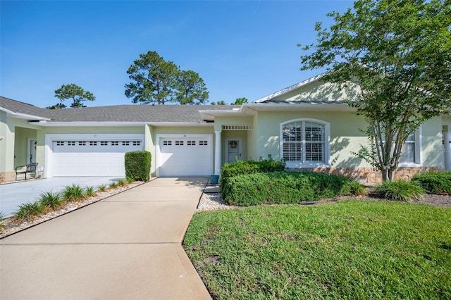 33 Veranda Way Unit 33, Palm Coast, FL 32137 - ranch-style home featuring a garage, concrete driveway, stucco siding, and stone siding
