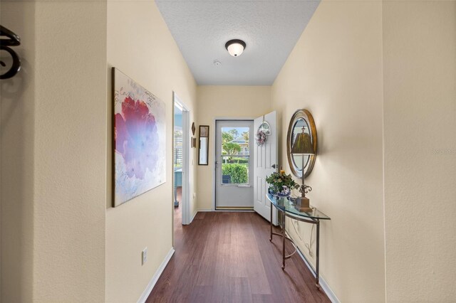 33 Veranda Way Unit 33, Palm Coast, FL 32137 - doorway to outside with wood finished floors, baseboards, and a textured ceiling