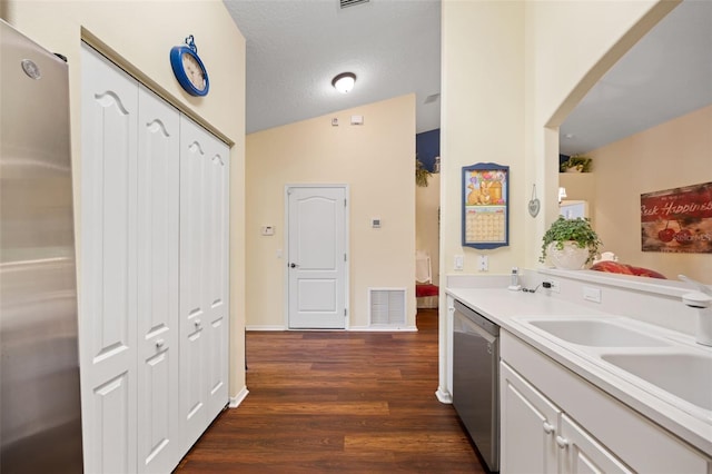 33 Veranda Way Unit 33, Palm Coast, FL 32137 - kitchen with appliances with stainless steel finishes, dark wood finished floors, a sink, white cabinetry, and light countertops
