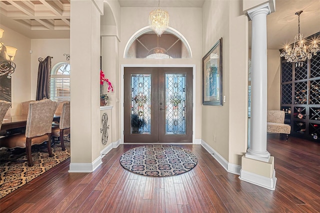 568 Luna Bella Ln, New Smyrna Beach, FL 32168 - entryway with a chandelier, decorative columns, hardwood / wood-style floors, baseboards, and a high ceiling