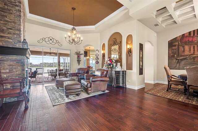 568 Luna Bella Ln, New Smyrna Beach, FL 32168 - living area featuring a towering ceiling, arched walkways, wood-type flooring, coffered ceiling, and a chandelier