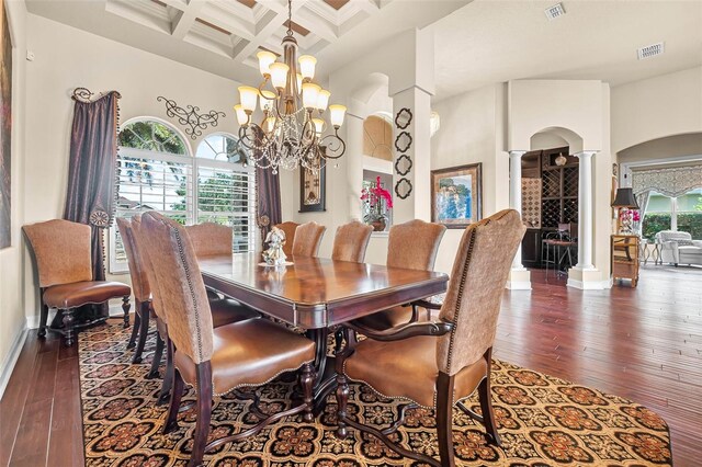568 Luna Bella Ln, New Smyrna Beach, FL 32168 - dining space with decorative columns, arched walkways, a chandelier, dark wood-style flooring, and beamed ceiling