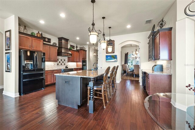 568 Luna Bella Ln, New Smyrna Beach, FL 32168 - kitchen featuring black appliances, custom range hood, a kitchen island with sink, tasteful backsplash, and recessed lighting