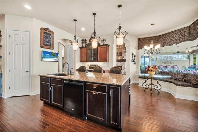 568 Luna Bella Ln, New Smyrna Beach, FL 32168 - kitchen with black dishwasher, a sink, arched walkways, dark wood-style floors, and a chandelier