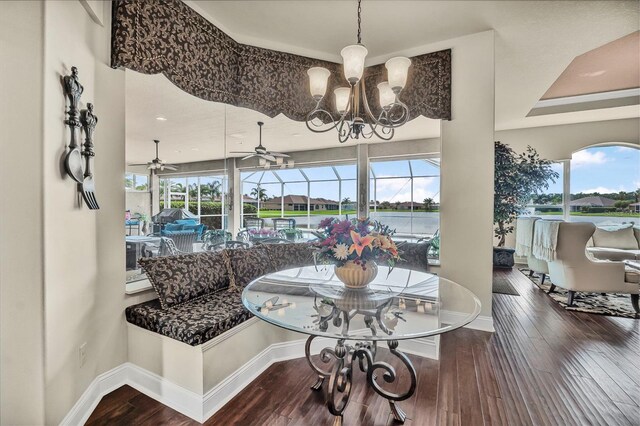 568 Luna Bella Ln, New Smyrna Beach, FL 32168 - dining room featuring baseboards, hardwood / wood-style floors, a chandelier, and a ceiling fan