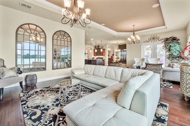 568 Luna Bella Ln, New Smyrna Beach, FL 32168 - living room with a chandelier, a raised ceiling, dark wood-type flooring, and recessed lighting