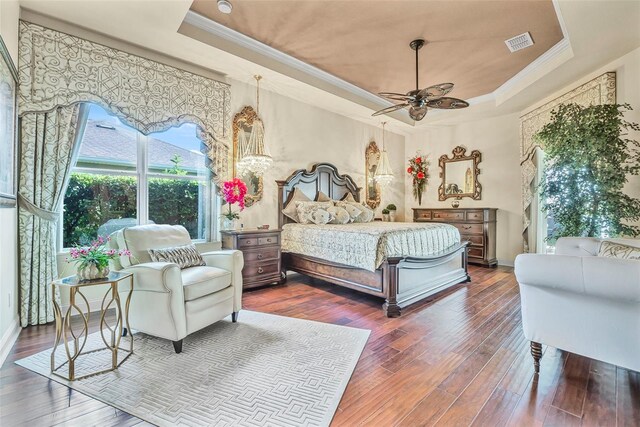 568 Luna Bella Ln, New Smyrna Beach, FL 32168 - bedroom with a tray ceiling, crown molding, hardwood / wood-style flooring, baseboards, and a ceiling fan