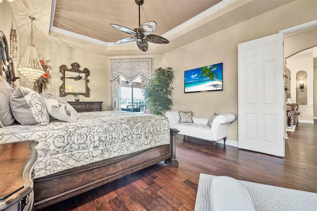 568 Luna Bella Ln, New Smyrna Beach, FL 32168 - bedroom with arched walkways, a raised ceiling, wood-type flooring, ornamental molding, and baseboards