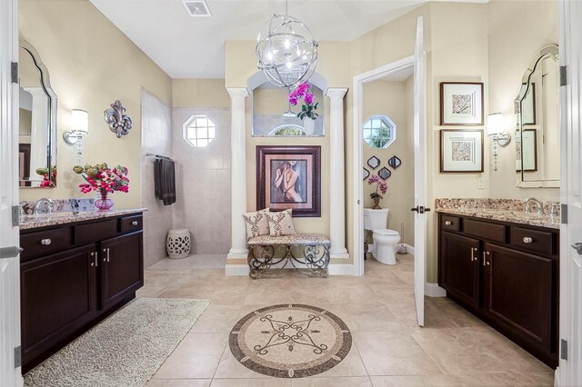 568 Luna Bella Ln, New Smyrna Beach, FL 32168 - bathroom with a walk in shower, tile patterned flooring, vanity, toilet, and ornate columns