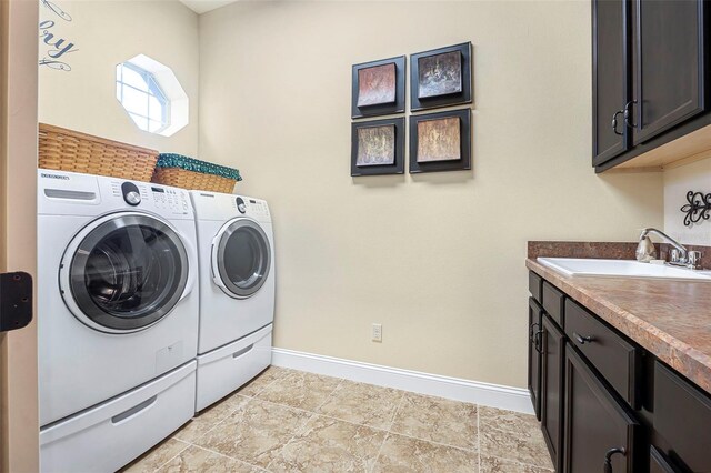 568 Luna Bella Ln, New Smyrna Beach, FL 32168 - washroom featuring washer and clothes dryer, baseboards, and cabinet space