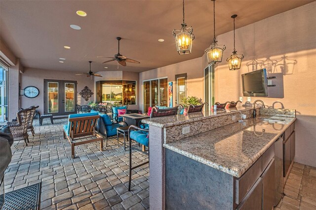 568 Luna Bella Ln, New Smyrna Beach, FL 32168 - kitchen featuring a sink, recessed lighting, stone tile floors, open floor plan, and a peninsula