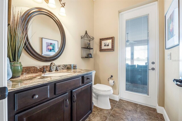 568 Luna Bella Ln, New Smyrna Beach, FL 32168 - bathroom with toilet, vanity, and baseboards