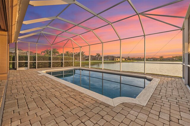568 Luna Bella Ln, New Smyrna Beach, FL 32168 - outdoor pool featuring a water view, a patio area, and glass enclosure