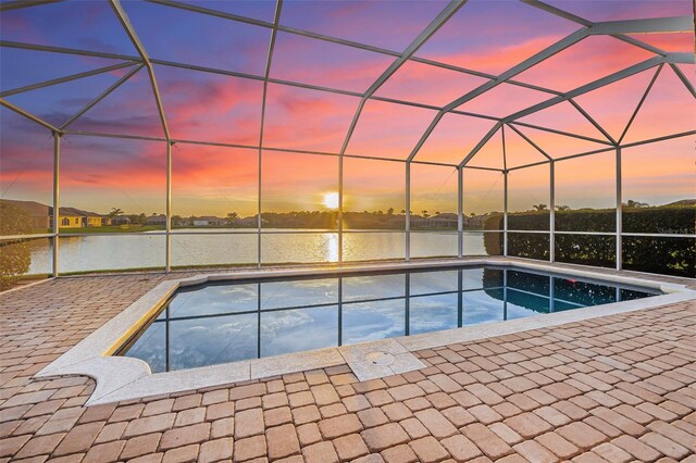 568 Luna Bella Ln, New Smyrna Beach, FL 32168 - pool at dusk featuring an outdoor pool and a water view