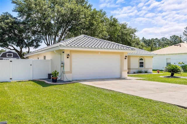 226 Pinegrove Dr, Palm Coast, FL 32164 - view of front facade featuring a gate, a tile roof, stucco siding, concrete driveway, and an attached garage