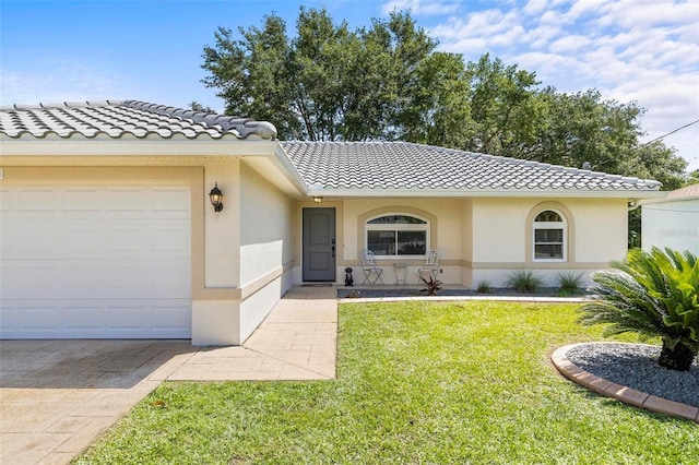 226 Pinegrove Dr, Palm Coast, FL 32164 - view of front facade featuring a tile roof, a garage, a front lawn, and stucco siding
