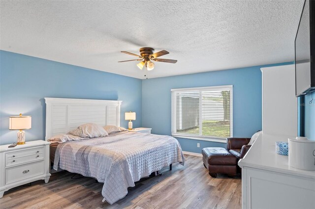 226 Pinegrove Dr, Palm Coast, FL 32164 - bedroom with light wood finished floors, baseboards, ceiling fan, and a textured ceiling