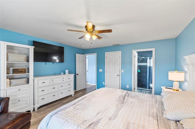 226 Pinegrove Dr, Palm Coast, FL 32164 - bedroom with wood finished floors, a ceiling fan, and ensuite bath
