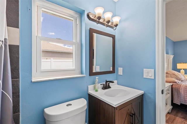 226 Pinegrove Dr, Palm Coast, FL 32164 - ensuite bathroom featuring vanity, toilet, and wood finished floors
