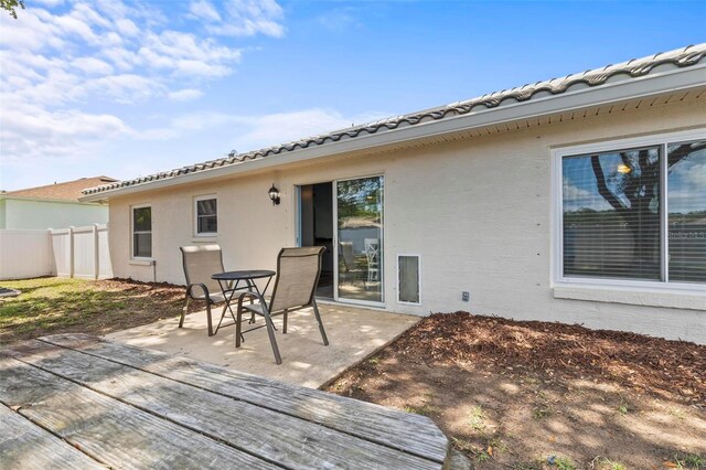 226 Pinegrove Dr, Palm Coast, FL 32164 - wooden deck with a patio area and fence