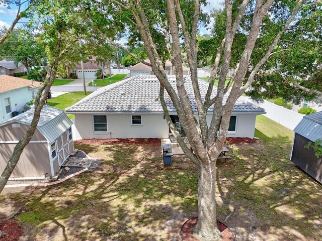 226 Pinegrove Dr, Palm Coast, FL 32164 - back of property featuring an outdoor structure, stucco siding, and a tile roof