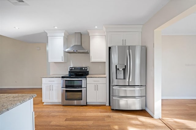 1317 Northside Dr, Ormond Beach, FL 32174 - kitchen featuring appliances with stainless steel finishes, wall chimney exhaust hood, white cabinetry, light wood-type flooring, and recessed lighting