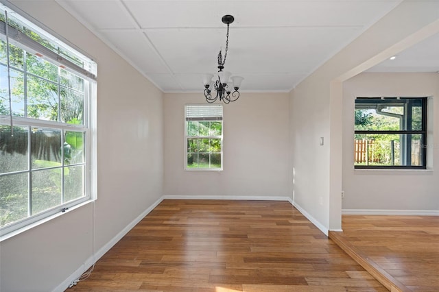 1317 Northside Dr, Ormond Beach, FL 32174 - unfurnished dining area with hardwood / wood-style floors, a chandelier, and ornamental molding