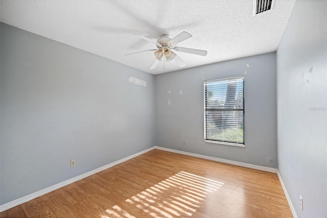 1317 Northside Dr, Ormond Beach, FL 32174 - spare room with wood finished floors, ceiling fan, and a textured ceiling