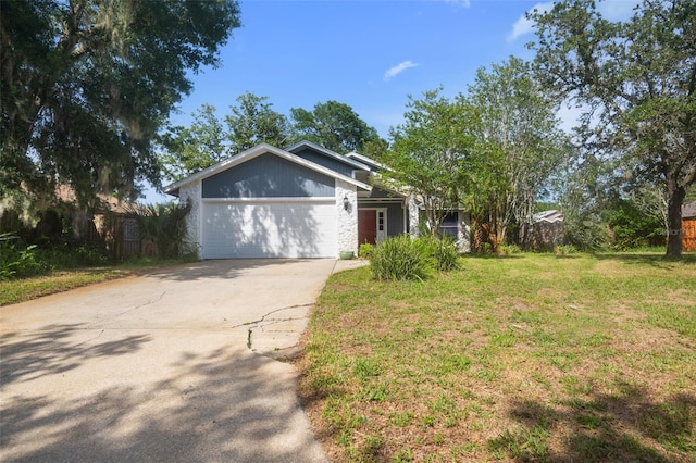 1317 Northside Dr, Ormond Beach, FL 32174 - view of front of home with an attached garage, concrete driveway, and a front lawn